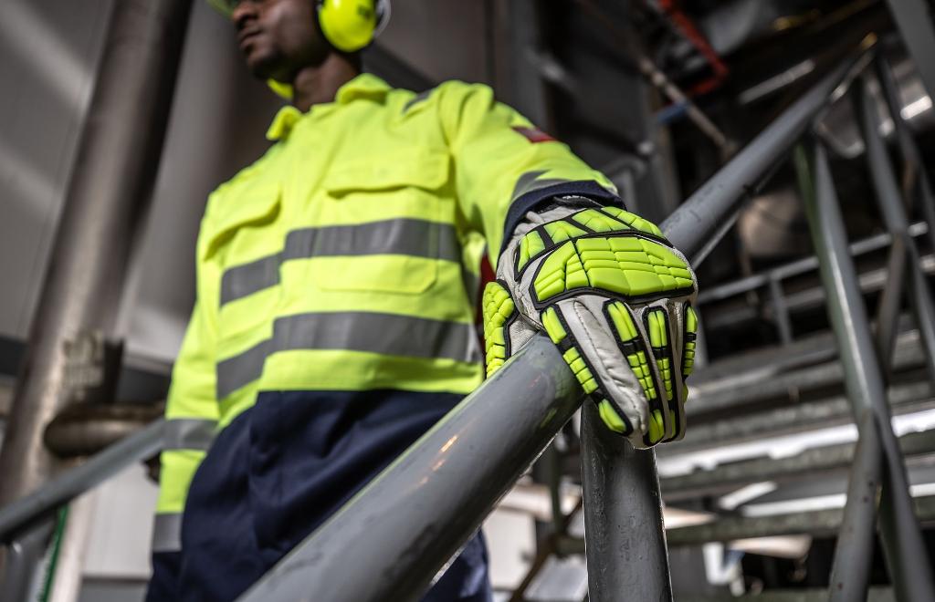 high vis safety gloves uniforms holding bannister