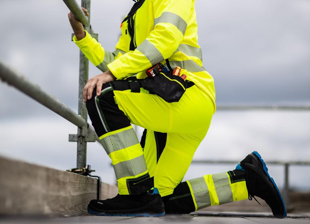 man kneeling in his vis yellow workwear