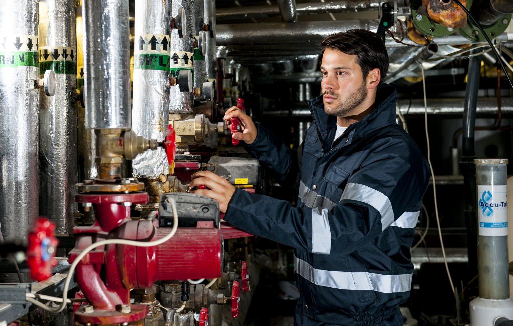 man wearing jacket uniform in an area of equipment