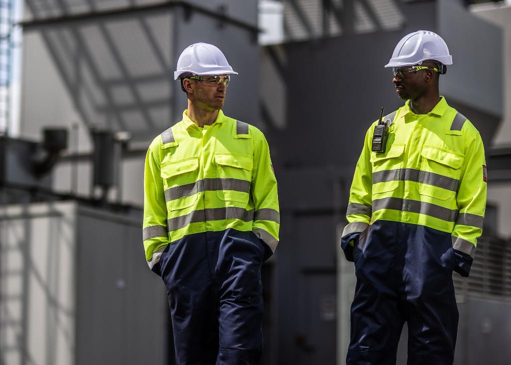 two men on work site with uniform and hard hat