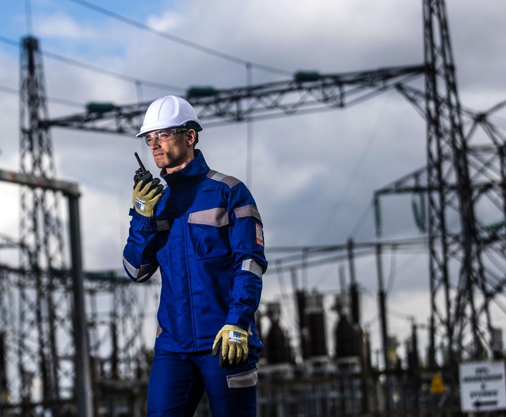 man on walkie talkie in blue safety workwear