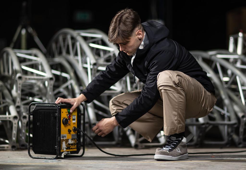 man looking at generator